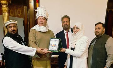 Receiving the Best Singer and Promoter of Pashto Music award in the United Kingdom